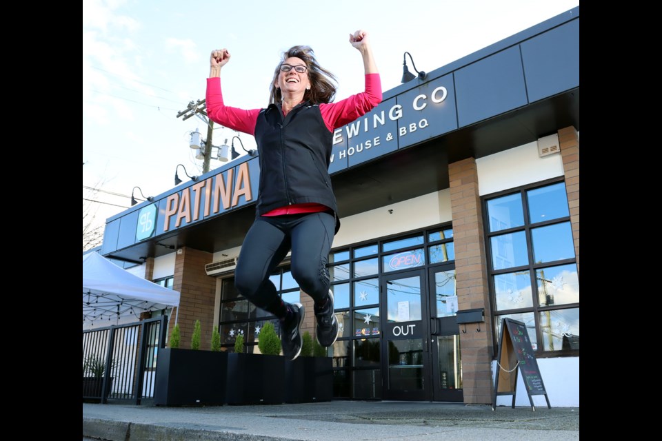 Coquitlam councillor Teri Towner jumps for joy after completing her quest to run every street in the Tri-Cities. She celebrated her achievement with a beer at Patina Brewery in Port Coquitlam.