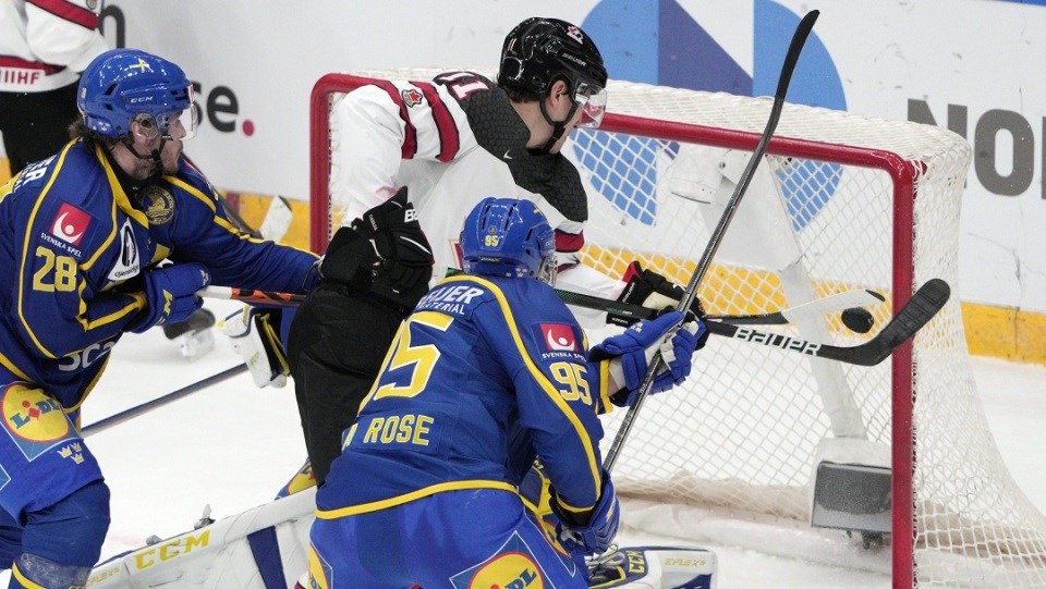 Port Moody's Adam Tambellini (#11) tries to bat a puck mid-air for Canada during an international competition against Sweden.