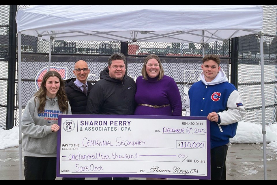 A $110,000 donation from Coquitlam philanthropist Sharon Perry (2nd right) was made on Dec. 6, 2022, to complete the funds needed for Centennial Secondary's new sports field score clock. She's also set to provide $10,000 over the next two years for maintenance.