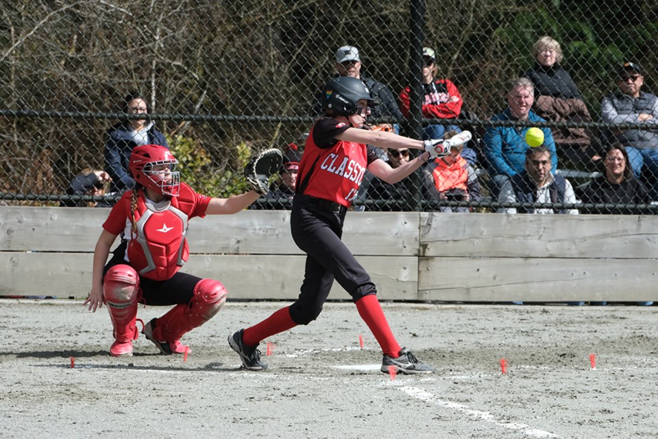 A batter hits a ball into play during the U15B Coquitlam Softball Classics showdown at the association's celebration event in Mundy Park on April 1, 2023.