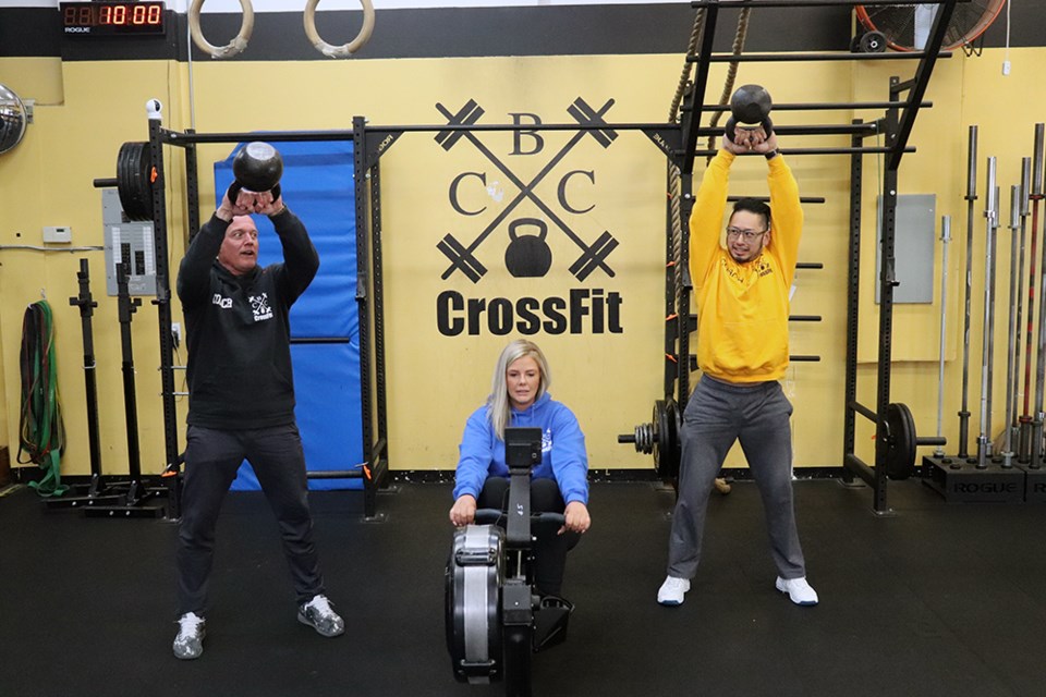 CrossFit CBC in Coquitlam are getting ready to host an in-person fundraiser for the first time since COVID-19 pandemic restrictions eased, which will see members compete in friendly competitions by donation with spectators and the public welcome to donate as well. [From left to right] Pictured are CrossFit CBC coach Greg Zeitler, and athletes Jennifer Bowden and Christian De Leon.