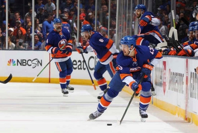 Coquitlam's Mathew Barzal (#13) skates with the puck for the New York Islanders during the 2021 NHL semi-finals against Tampa Bay.