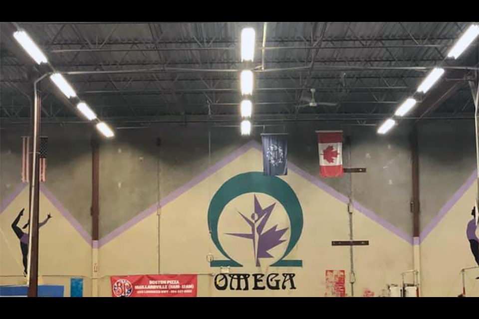 A former gymnast at Omega Gymnastics in Coquitlam is named in a class-action lawsuit that alleges sexual, physical and emotional abuse from two coaches when she was nine years old.