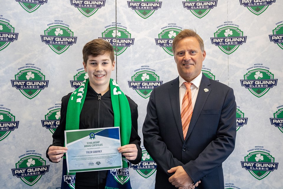 Burnaby's Tyler Godfrey (left) with former Vancouver Canuck Cliff Ronning after receiving a $1,000 scholarship at the 2021 Pat Quinn Classic tournament.