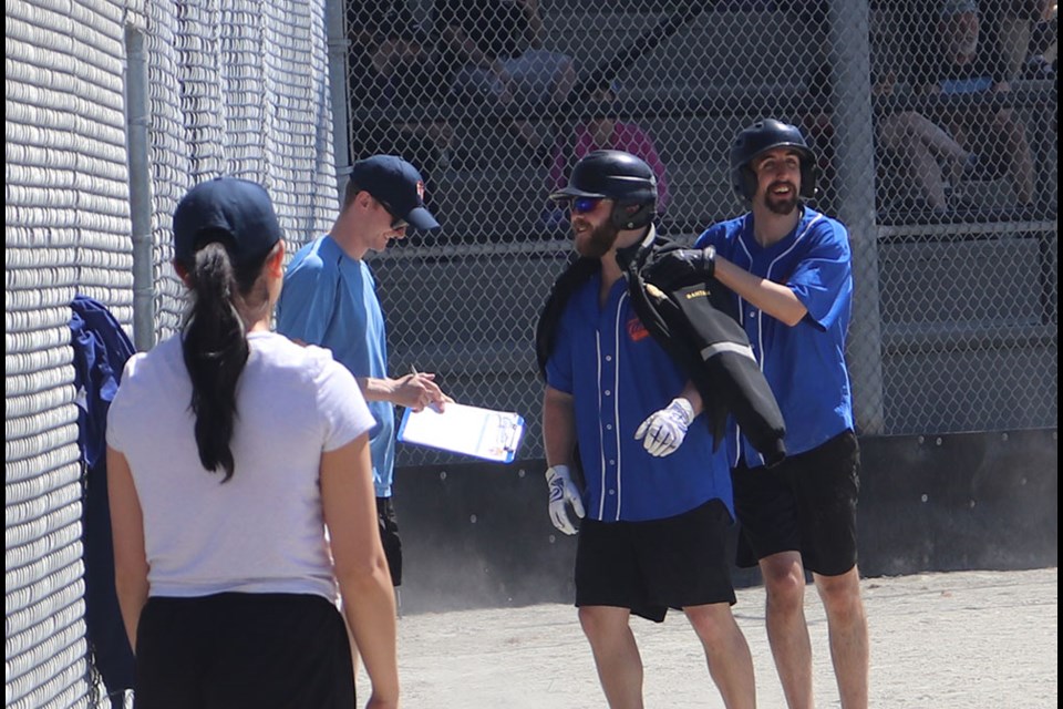 The Coquitlam Tigers award the home-run jacket to one of its batters after scoring a couple against the Burnaby Red Sox during the 2023 PoCo Minor Softball Special Olympics slo-pitch tournament at McLean Park on June 3, 2023.