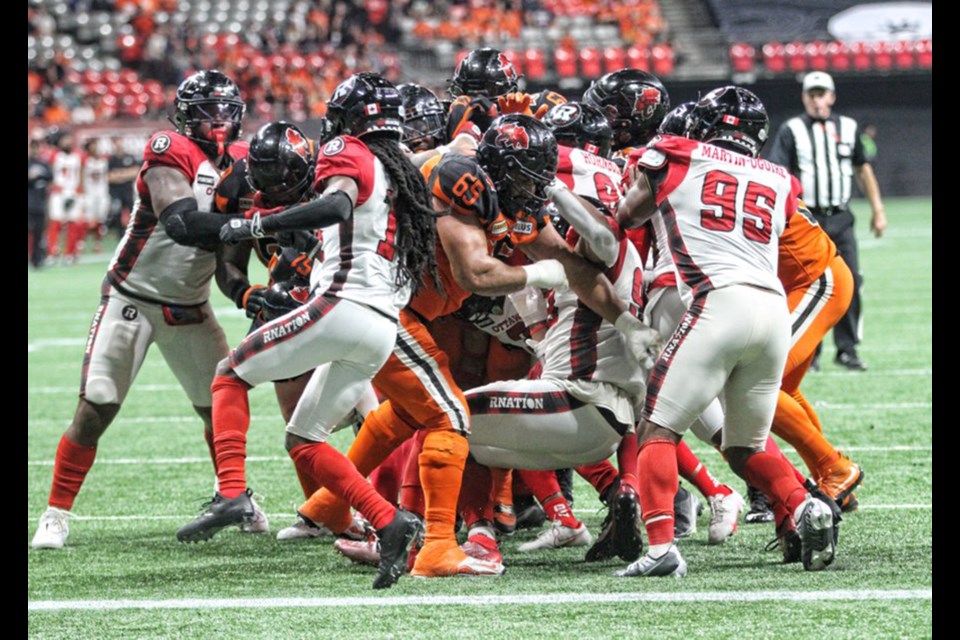 Offensive lineman Sukh Chungh (#65) of Port Coquitlam blocks for the BC Lions during a CFL game.