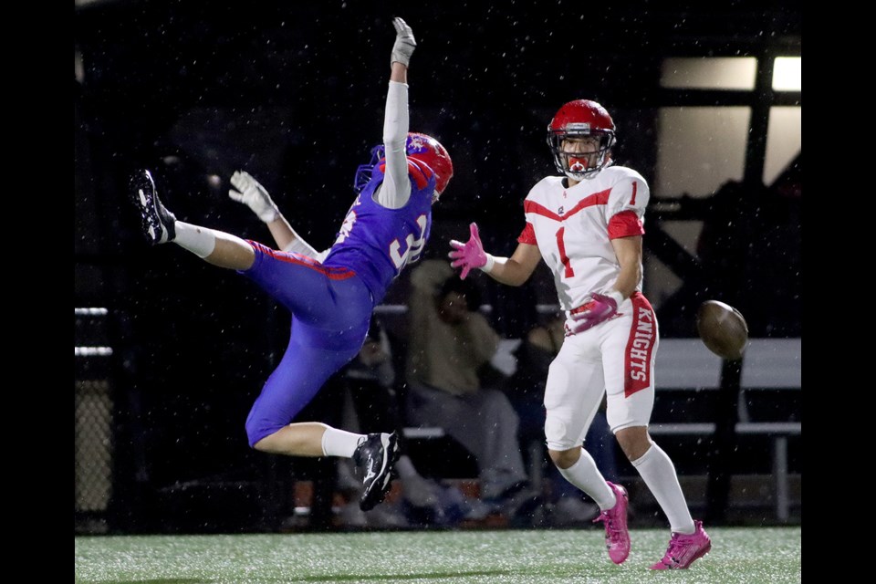 Centennial Centaurs defensive back Drew Cavanagh knocks a pass away from St. Thomas More Knights receiver Niko Kanagawa in the first half of their BC Secondary Schools Football Association game, Friday at the Centennial turf field.
