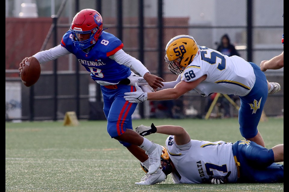 Centennial Centaurs quarterback Rohan Aulakh tries to slip away from South Delta Sun Devils tacklers Joshua Groenwold and Tyler De Dios n the first quarter of their BC Secondary Schools Football Association game, Friday at Centennial's turf field. The Sun Devils defeated the Centaurs 21-12.