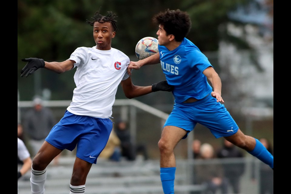 Port Moody Blues defender Mathiaz Buenfil battles a Centennial Centaurs forward in the first half of their Fraser North senior boys high school soccer zone championship match, Thursday at the Burnaby Lake Sports Complex West. Port Moody won 2-1.
