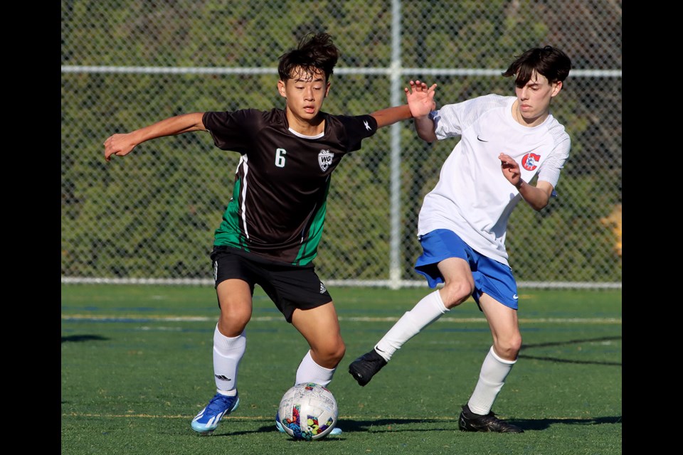 Centennial Centaurs defender Markus Latorre is knocked off the ball by a Walnut Grove forward in the second half of their opening round match at the BC Secondary Schools AAA senior boys soccer provincials, Thursday at the Burnaby Lake Sports Complex West.