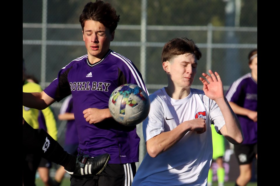 Centennial Centaurs forward Nick Matheson (right) battles a Royal Bay Ravens defender for control of the ball in the second half of their semifinal match at the 2023 BC Secondary Schools AAA senior boys’ soccer championships in Burnaby on Friday, Nov. 24.