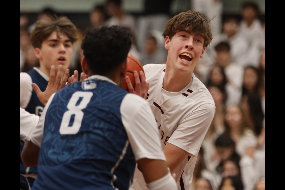 Heritage Woods Kodiaks forward Benjamin Peterson looks for a way to get to the basket in the first quarter of the Port Moody team's opening round game against the GW Graham Grizzlies on Nov. 30, 2023, at the Kodiak Klassic senior boys basketball tournament.