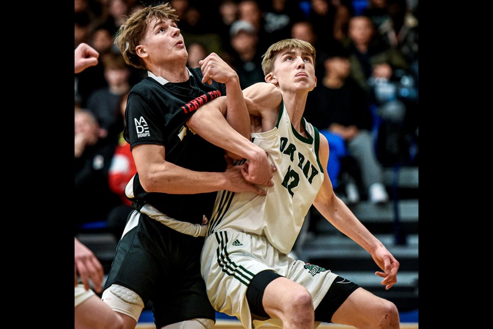 Maxsym Cichecki of the Terry Fox Ravens battles an Oak Bay defender for position under the basket in their semi-final game at the BC High School Jr. Boys Invitational basketball tournament, Monday at the Langley Events Centre.