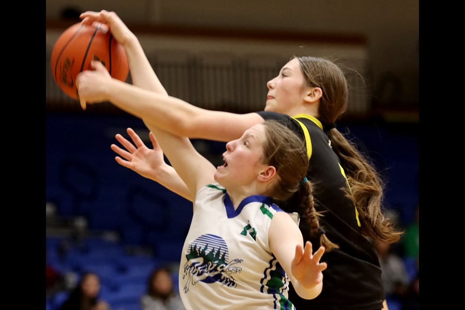 Riverside Rapids Rae Roycroft battles for an offensive reboudn with a Kelowna Owls defender in the first half of their BC High School AAAA senior girls basketball quarter final game, Thursday at the Langley Events Centre.