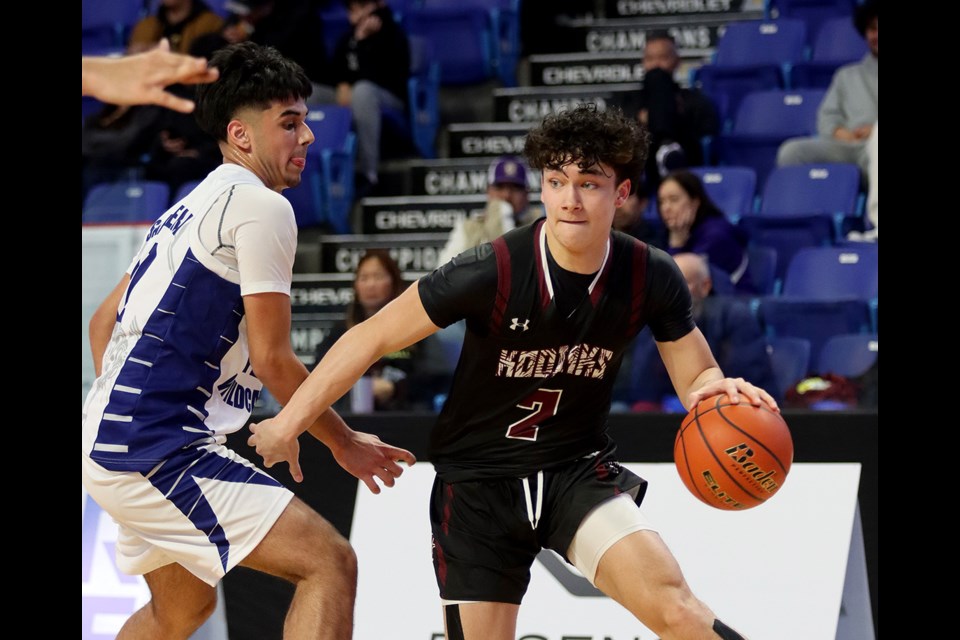 Heritage Woods Kodiaks drives past a Tamanawis Wildcats defender in the first half of their first round match at the BC School Sports AAAA senior boys provincial basketball championships, Wednesday at the Langley Events Centre.