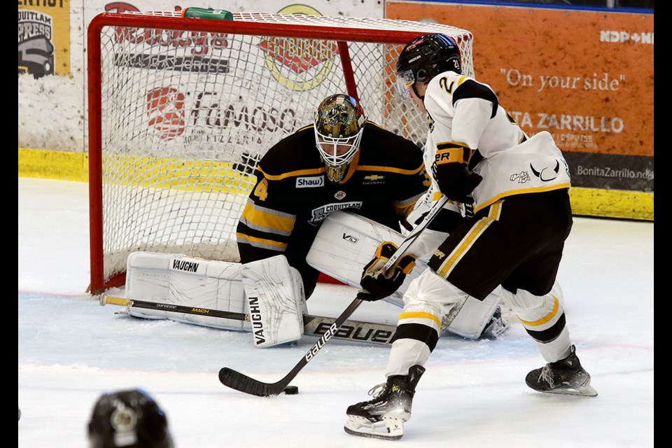 Coquitlam Express goalie Adam Manji makes a save on Victoria Grizzlies forward Anthony Carone in the first period of their BC Hockey League game, Saturday at the Poirier Sport and Leisure Complex.