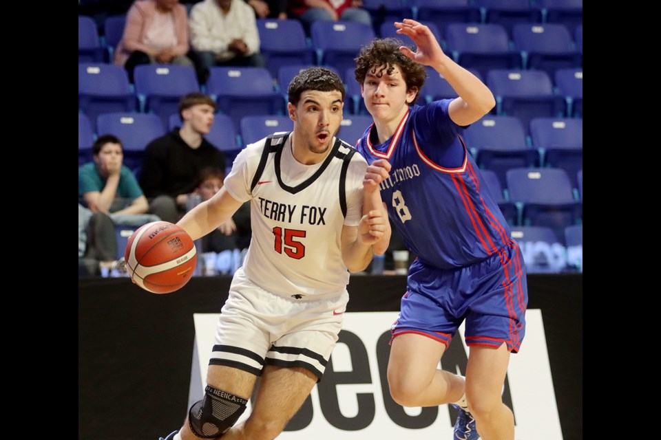 Terry Fox Ravens forward Matthew Schnear drives to the basket around a Semiahmoo defender in the first quarter of their opening round game at the BC School Sports AAAA boys basketball provincial championships, Wednesday at the Langley Events Centre.