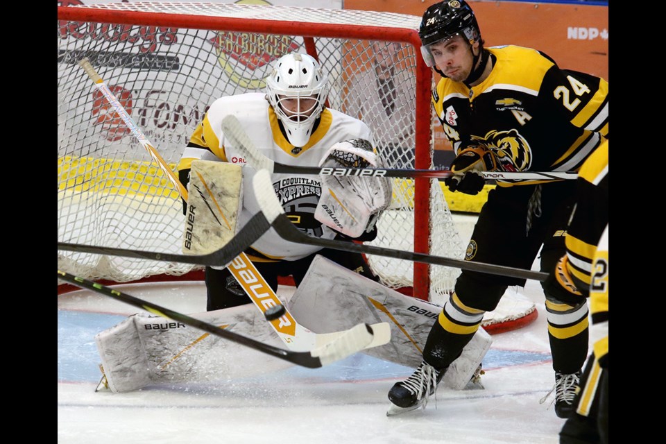 Coquitlam Express goalie Andrew Ness makes a save as Victoria Grizzlies forward Julian Cull eyes a deflection in the first period of game six of their BC Hockey League playoff series, Sunday at the Poirier Sport and Leisure Complex.