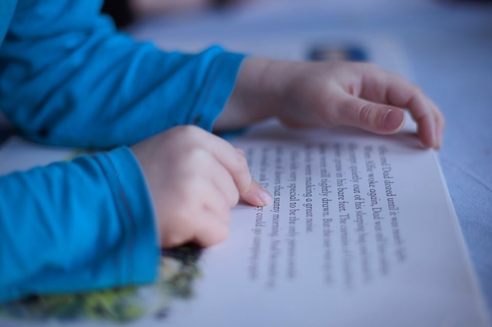 Child reading a book - Getty Images