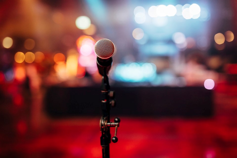 Microphone on stage stand up comedy - Getty Images
