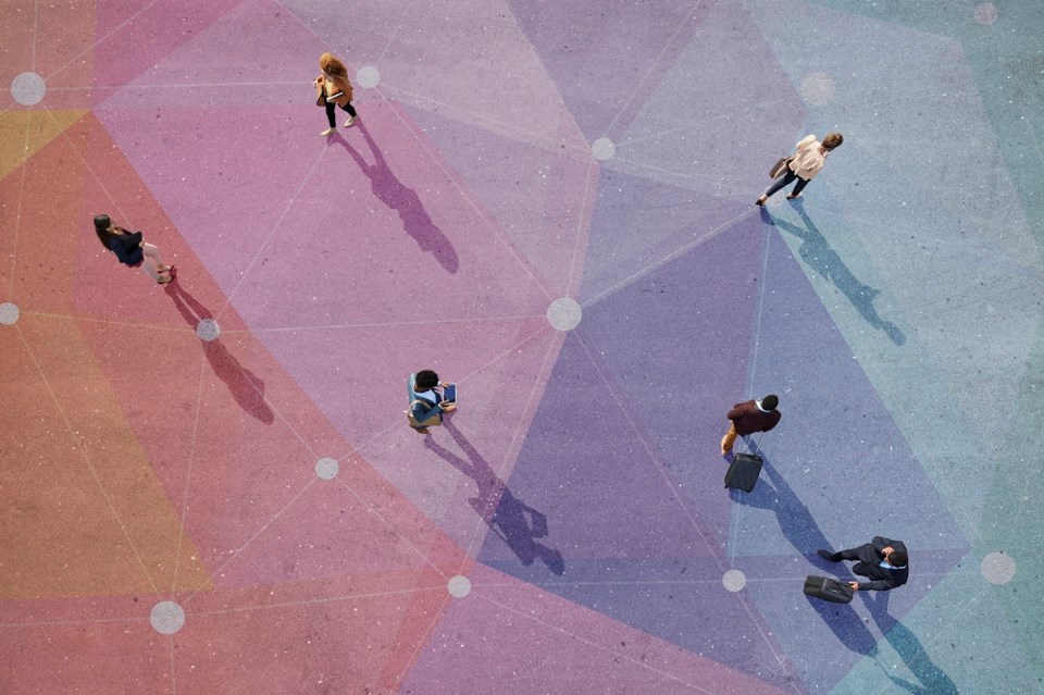 People walking on colourfully-shaped plaza - Getty Images