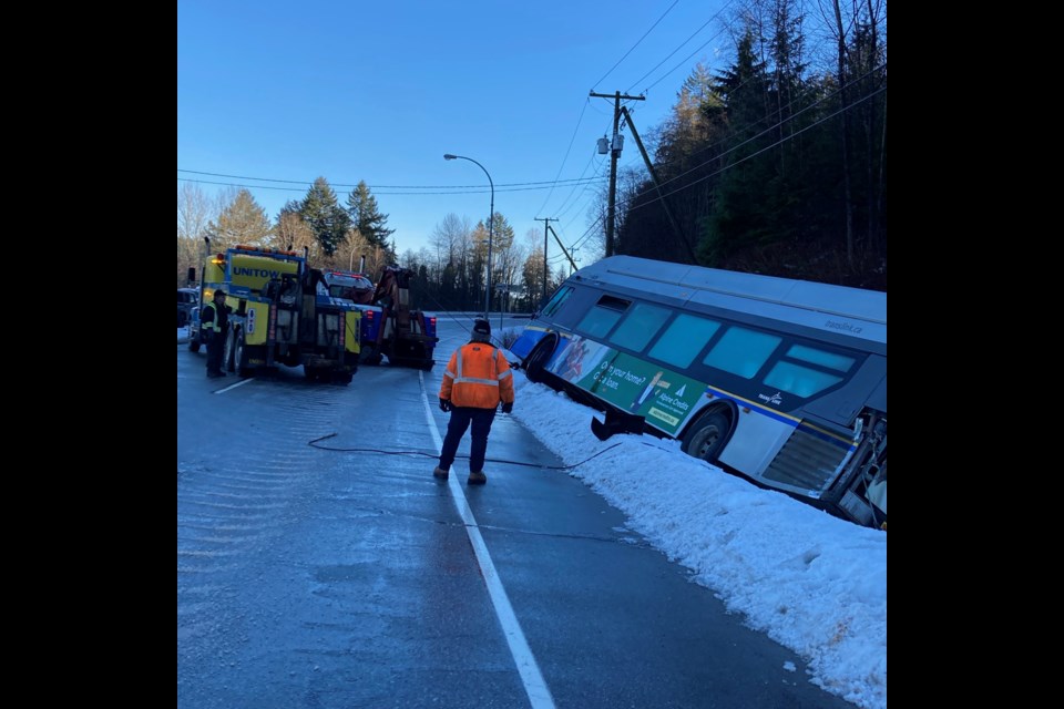 A TransLink bus was knocked into a ditch by a truck in an accident on Barnet Highway Sunday morning.