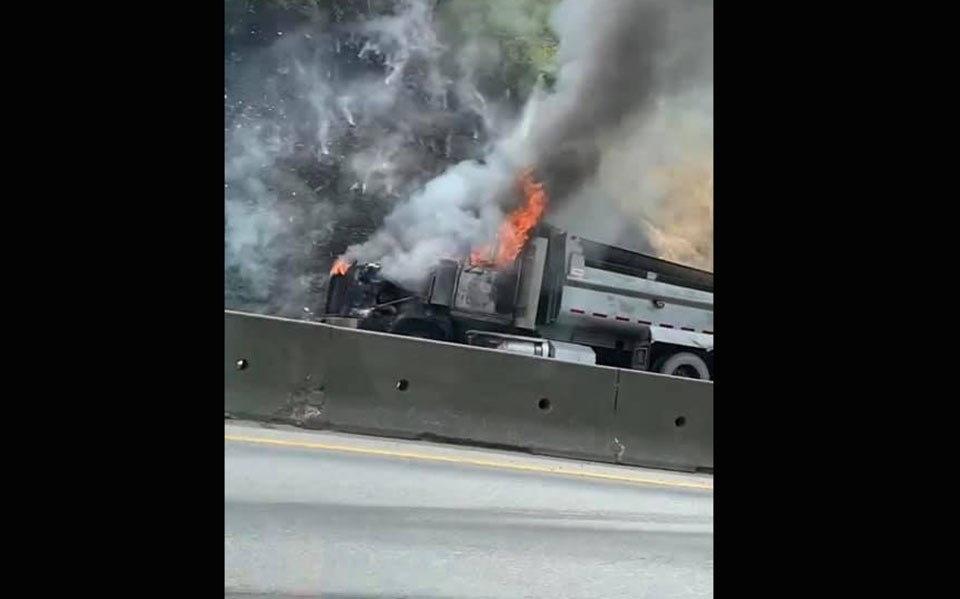 A dump truck appears to be on fire along the Mary Hill Bypass in Port Coquitlam on July 7, 2021.