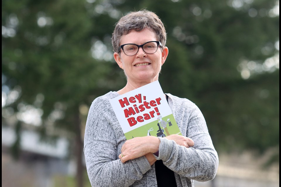 Tri-City News reporter Diane Strandberg with the book Hey, Mister Bear written by Jim Peacock.