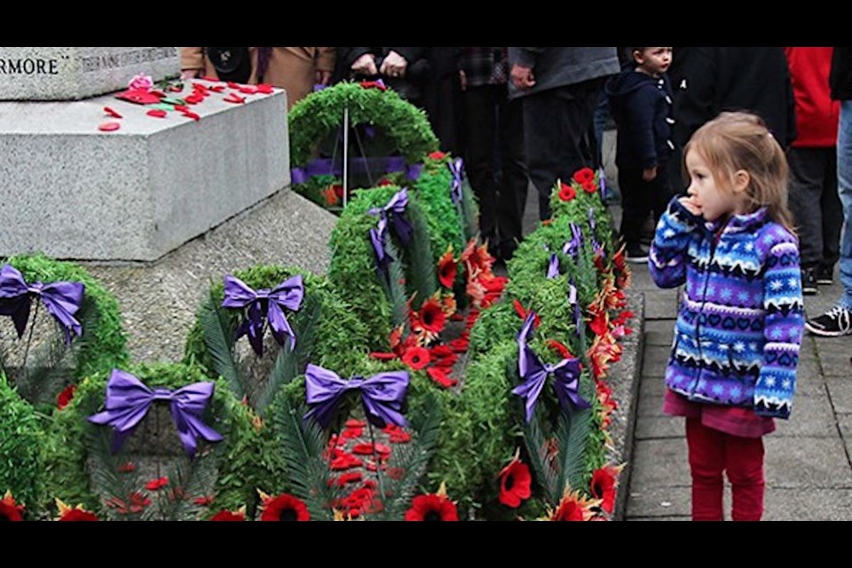 A child remembers veterans at the Port Coquitlam cenotaph in this file photo by Mary Ness.