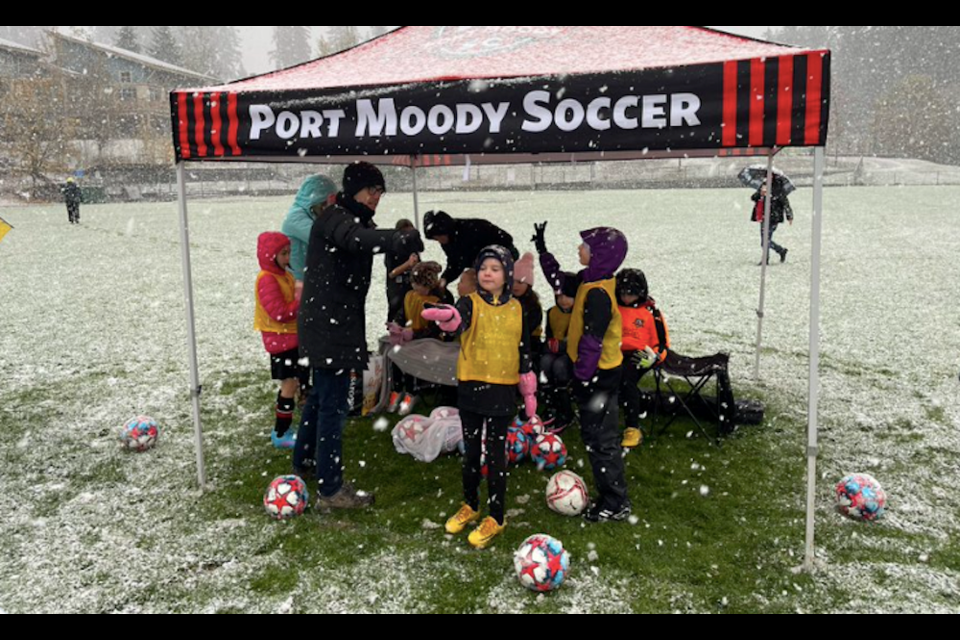 Girls playing soccer in Port Moody are kept dry from the snow. Keir Macdonald/Twitter