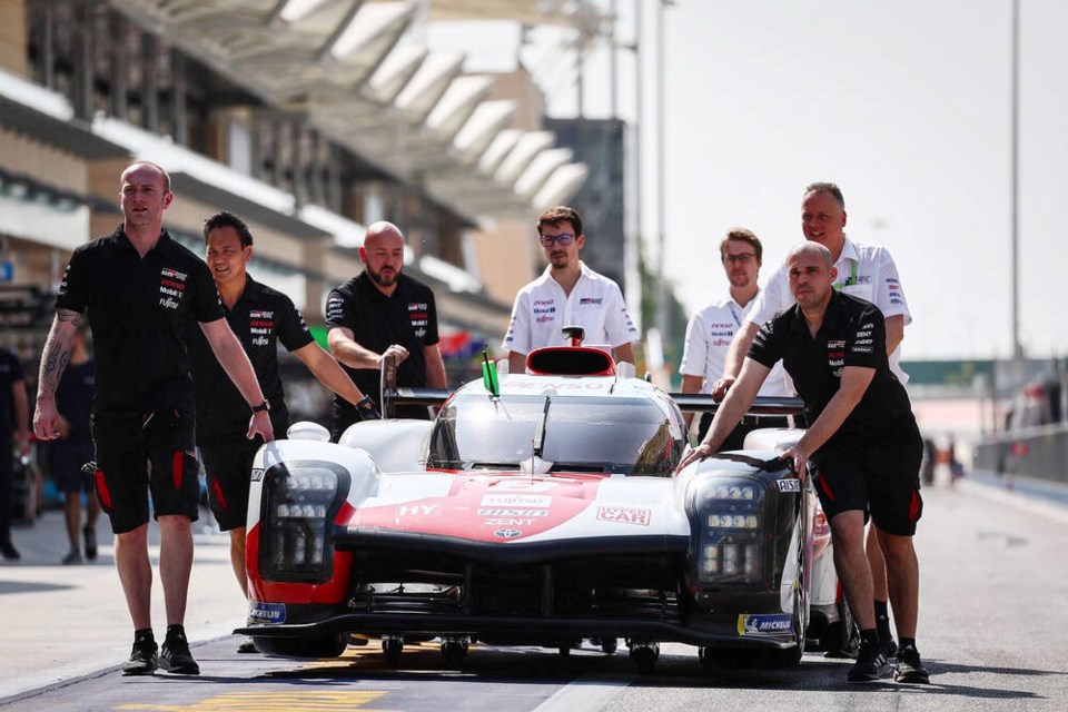 Coquitlam’s Ryan Dingle [third right], helps push one of Toyotas HyperCars through the paddock. He’s a race engineer for the company’s endurance racing program, which is defending its five-time championship at the 24 Hours of LeMans, June 10-11. | Submitted