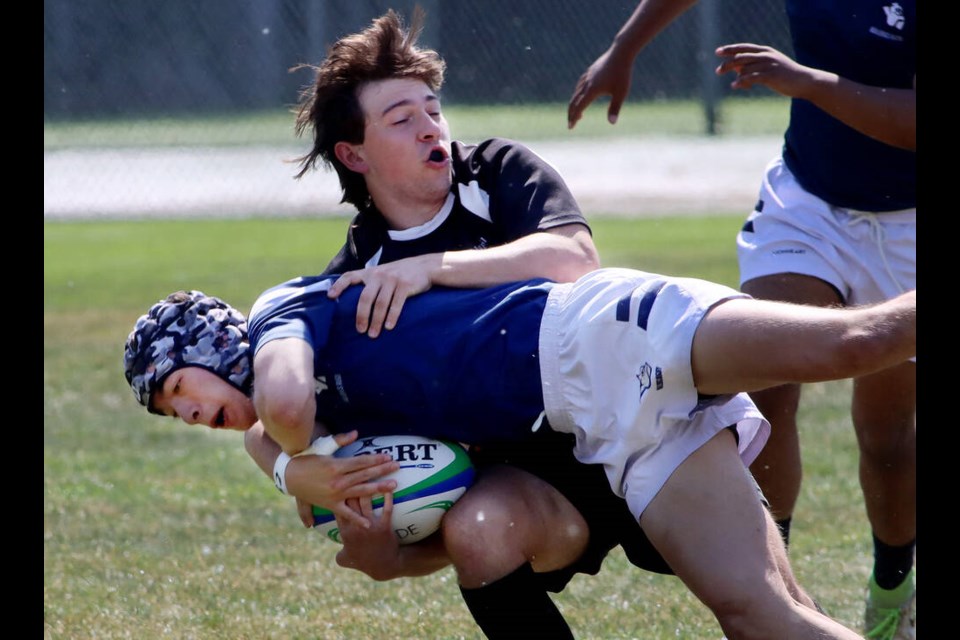 Gleneagle Talons' Matthew Bailey hauls down Byrne Creek Bulldogs ball carrier Sammy Srobotnjak in the first half of their Fraser North senior boys' rugby AA championship on Thursday (May 25) at Gates Park in Port Coquitlam. Gleneagle won 46-6. | Mario Bartel, Tri-City News