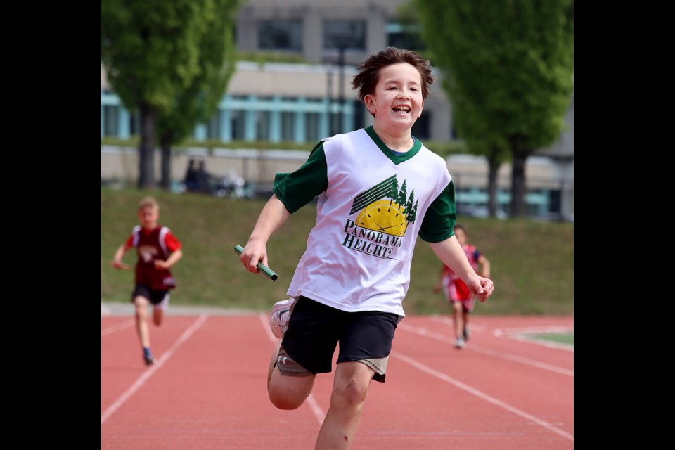 Sammy Zaitscoff-Choy is all smiles as he brings home a victory for Panorama Heights, running the anchor leg of the Grade 5 boys' 4x100 relay at the annual School District 43 elementary track and field meet held at Simon Fraser University on Wednesday (May 24). | Mario Bartel, Tri-City News 