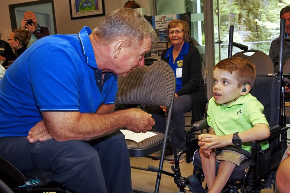 PAUL STEEVES PHOTO | Rick Hansen chats with another visitor at the Mossom Creek fish hatchery prior to the official unveiling of a plaque recognizing its gold status for accessibility by the Rick Hansen Foundation. 