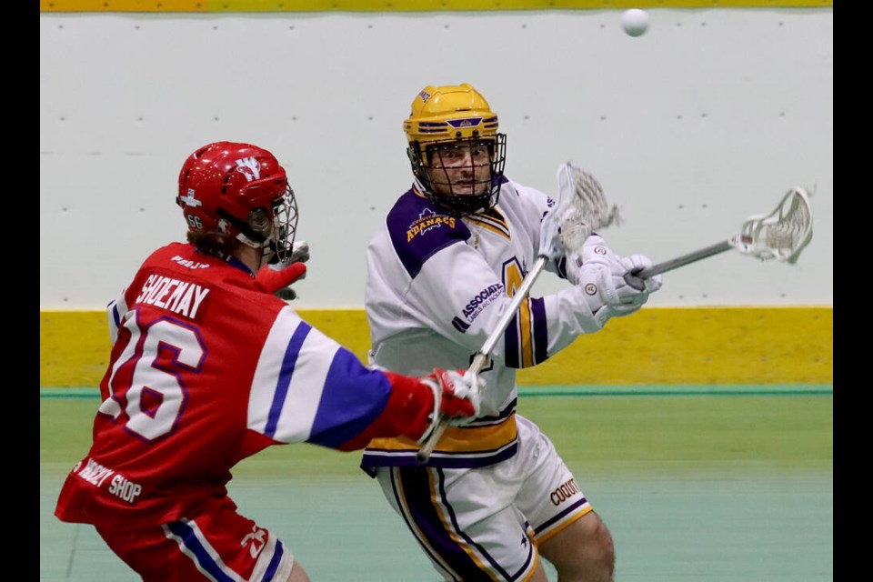 Coquitlam Adanacs defender Eli Batt loses the ball as he's checked by Patrick Shoemay of the New Westminster Salmonbellies in the first period of their Western Lacrosse Association game on June 1, 2023, at Queen's Park Arena. New West won 15-6. | Mario Bartel, Tri-City News