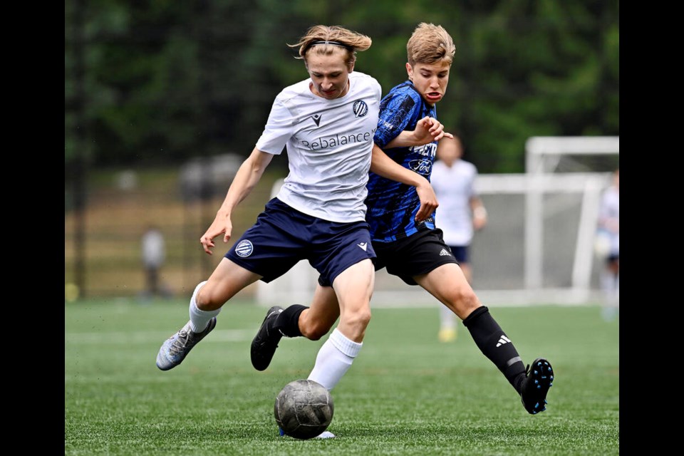 Coquitlam Metro-Fords Tyler Magdalinski battles a Vancovuer Island Wave forward for the ball in their BC Premier Cup semifinal match, last Saturday at Town Centre Park. CMFSC won 3-0. | Jennifer Gauthier, Tri-City News 
