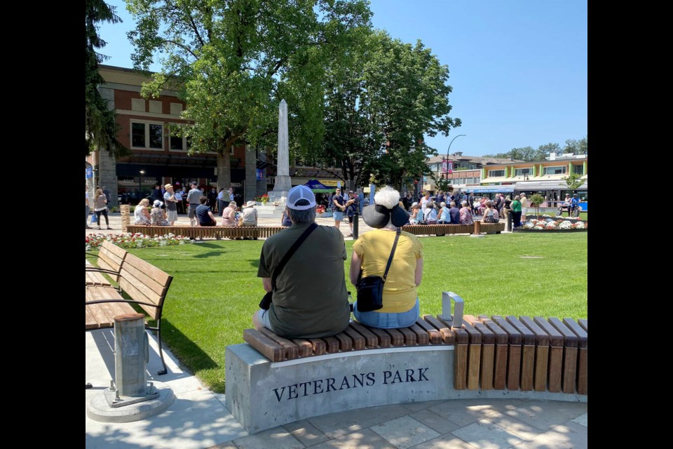 Passersby check out the new seating in Port Coquitlam's Veterans Park as they wait for the official ceremony re-opening the square in front of city hall on Tuesday. | Diane Strandberg, Tri-City News