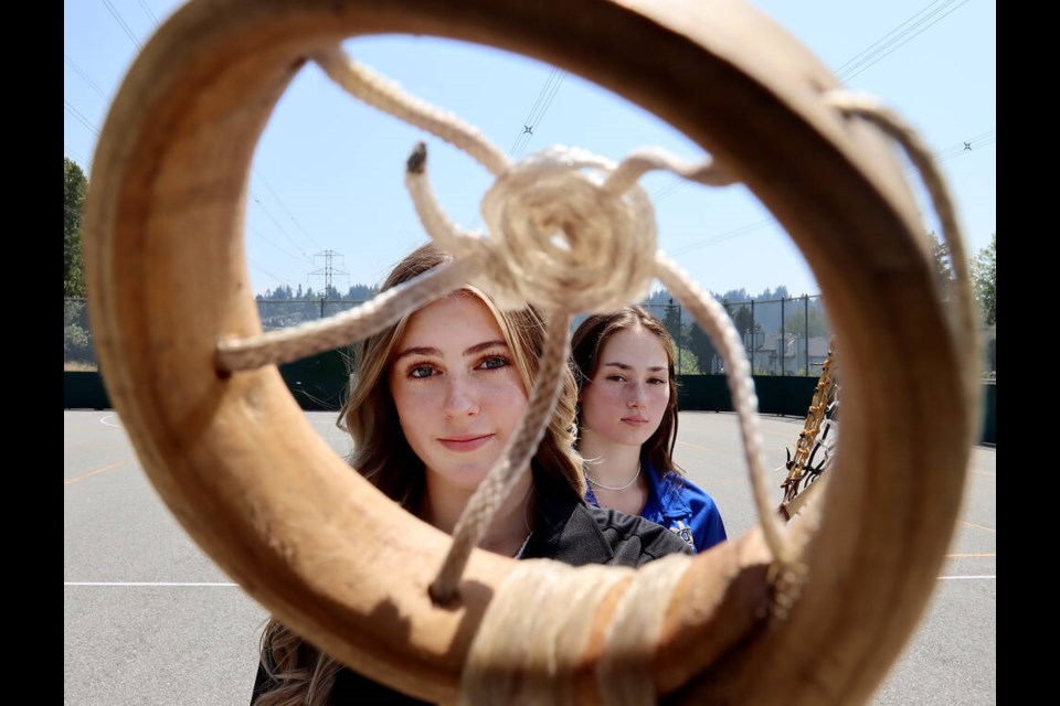 Jolaine Bolam and her sister, Jordan, are framed by a vintage lacrosse stick as they prepare to head to Halifax-Dartmouth where they'll be part of Team BC's U19 women's lacrosse team competing at the North American Indigenous Games. | Mario Bartel, Tri-City News