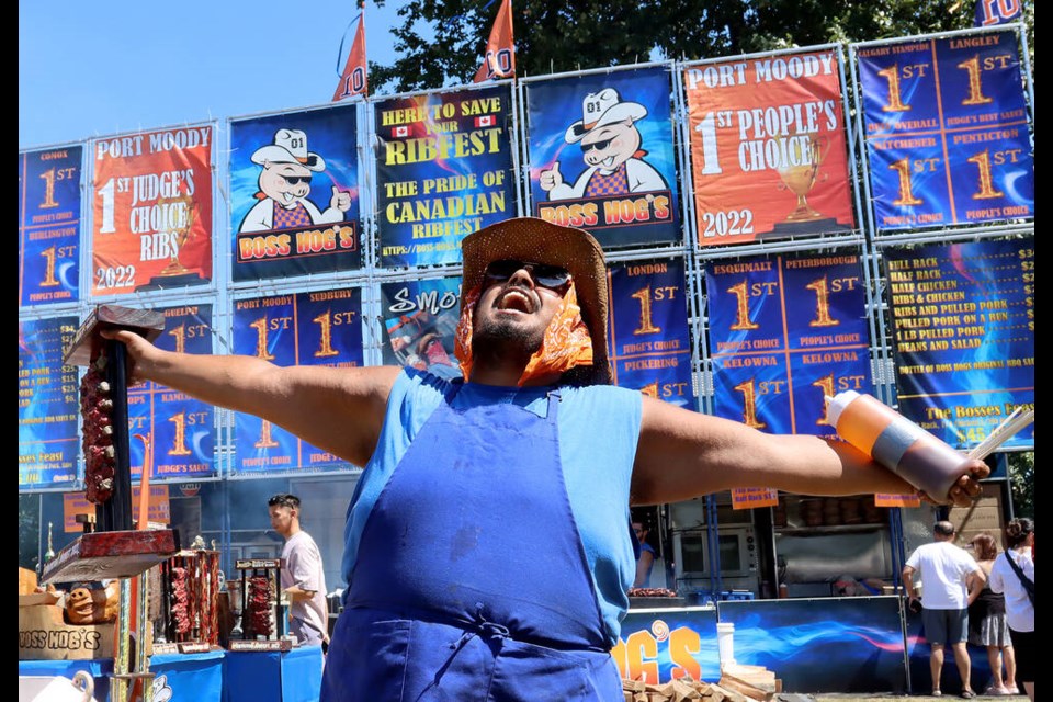 Rahim “Big Delicious” Berisha tries to entice hungry visitors to his Boss Hob’s stand, Friday (July 21) at Port Moody’s RibFest in Rocky Point Park. | Mario Bartel, Tri-City News