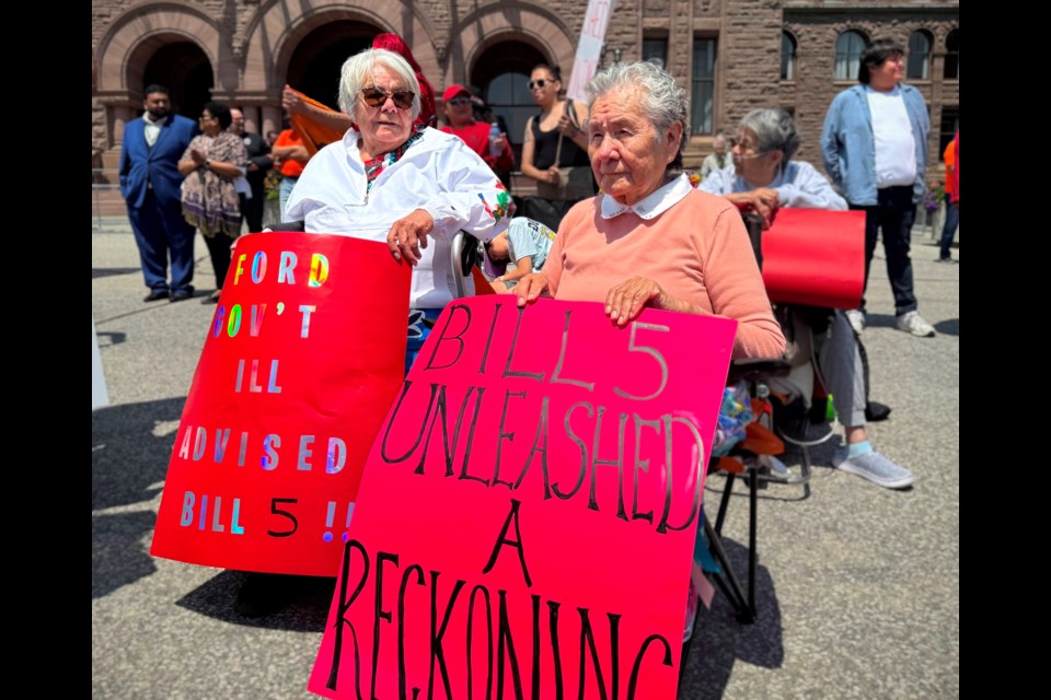 Myna Toulouse of Sagamok First Nation holds a sign at a rally at Queen's Park on Monday, June 2, 2025, warning that Bill 5 has "unleashed a reckoning."