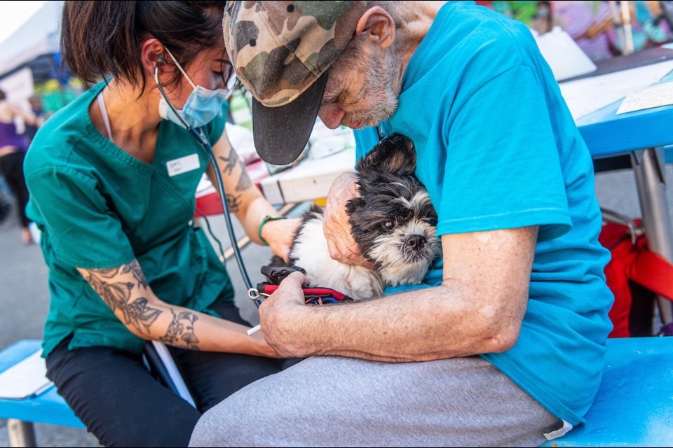 Dr. Doris Leung supporting Ozzie the dog at the Pet Fair People Care Event in June 2021.