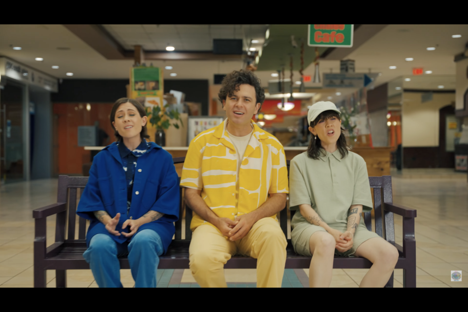 Tegan and Sara Quin flank Max Kerman of Arkells in Vancouver's Kingsgate Mall in a music video for "Teenage Tears."