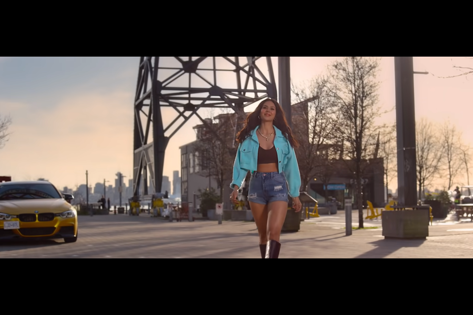 A screen capture from the trailer for Honsla Rakh shows Sonam Bajwa walking in the Shipyards District in North Vancouver.