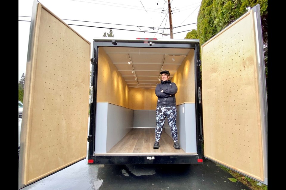 Sara Quine in her Shoebox Gallery that can now travel around Vancouver.