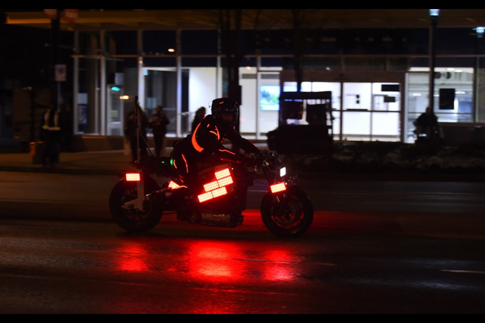 One of the "light cycles" on Cambie Street; the street was wetted by a truck as part of the Tron: Ares production..