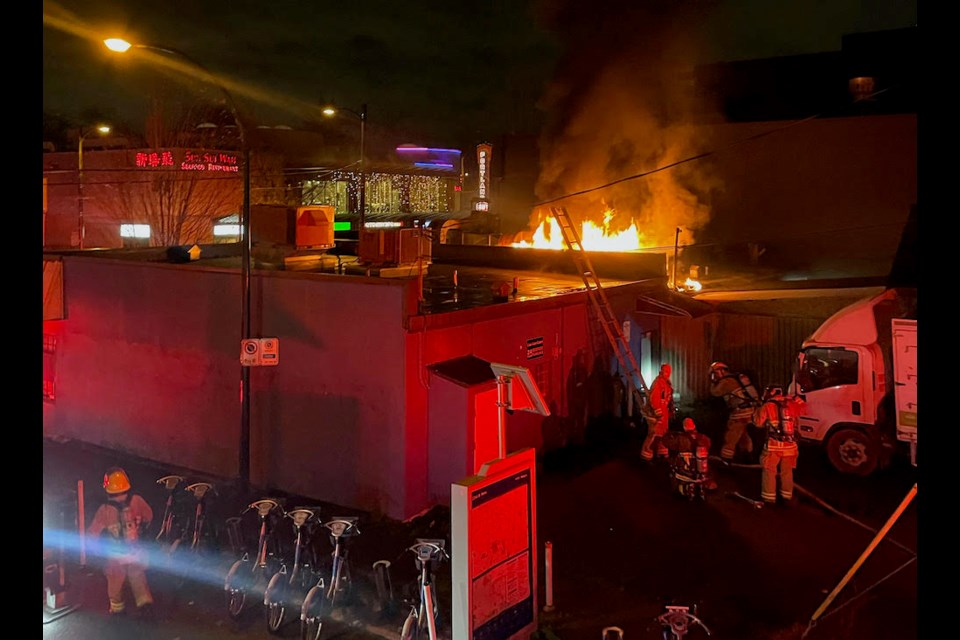 Vancouver Fire Rescue Services tackle a blaze on Main Street near 22nd Avenue early on Nov. 6, 2023