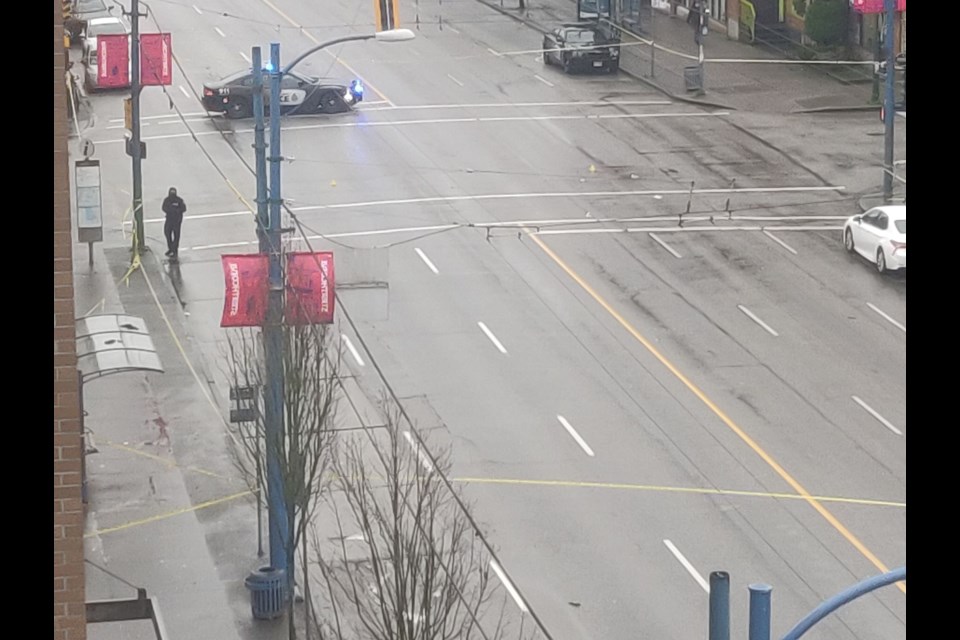 Police watch over the scene at East Hastings and Princess Streets.