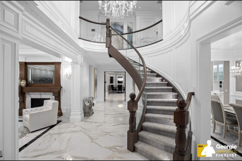 The foyer of this thoughtfully-built Vancouver home blends high-end modern and traditional style seamlessly. Photo courtesy of REW.ca