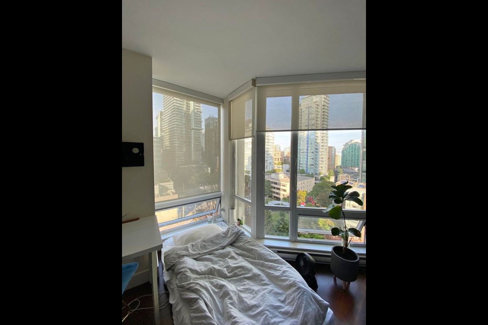 A bright and airy semi-private living room is available for rent in a Downtown Vancouver apartment. 