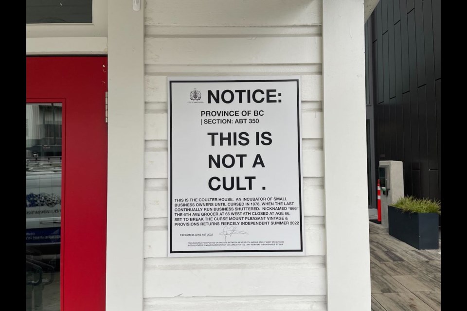 A sign on the exterior of a restored heritage home connected to a modern mixed-use development in Vancouver's Mount Pleasant has a lot of people wondering what goes on at the property